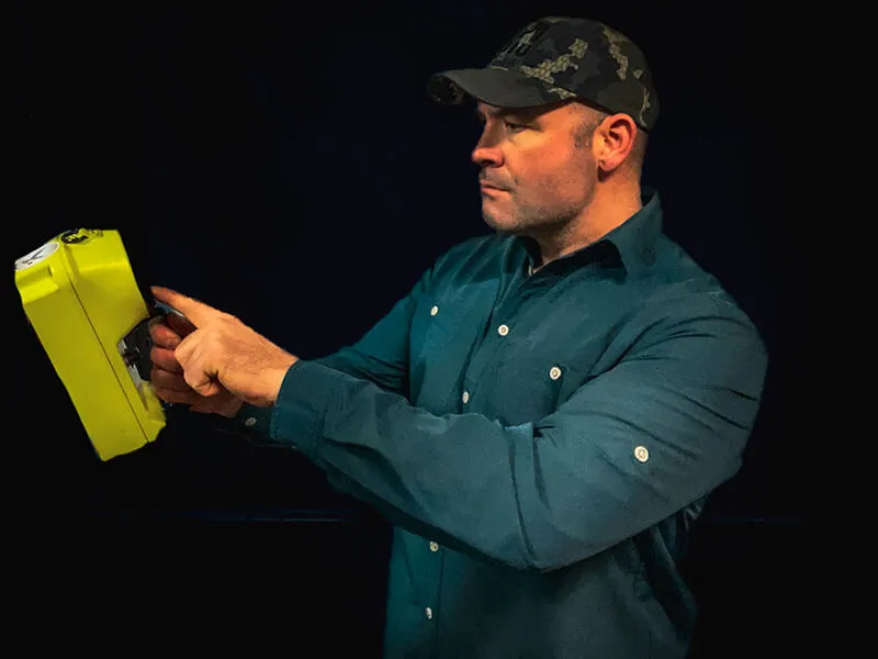 Ed Hubbell holding a handheld XRF analyzer