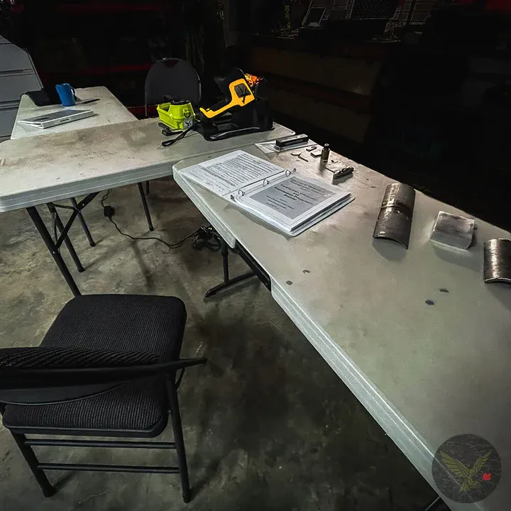 Classroom table set with an XRF analyzer and course binders